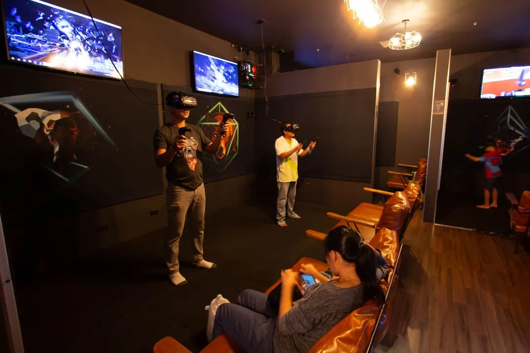 Guests playing VR side by side at Total VR Ekamai